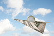 euro coin flying on dollar plane