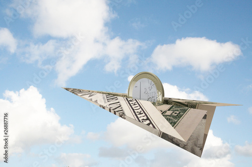 Photo: euro coin flying on dollar plane euro coin flying on dollar plane