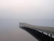 Jetty at a lake in foggy morning