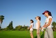 Golf three woman in a row green grass course Golf three woman in a row green grass course