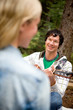 Man Serenading a Woman with Guitar Man Serenading a Woman with Guitar