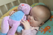 baby sleeping with a cuddly toy baby sleeping with a cuddly toy