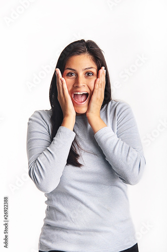 Photo: Excited young woman holding her face Excited young woman holding her face