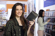 Happy woman at the video rental store