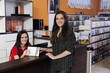 Employee handing over dvd at the video rental store