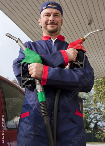 Photo: Gas Station Worker Refilling Car at Service Station Gas Station Worker Refilling Car at Service Station