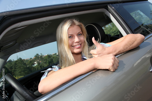 Photo: Young woman driving new car Young woman driving new car
