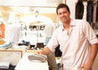 Photo: Male Sales Assistant At Checkout Of Clothing Store Male Sales Assistant At Checkout Of Clothing Store