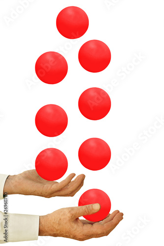 Photo: Businessman juggling too many balls in the air - on white Businessman juggling too many balls in the air - on white
