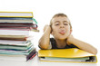 Child sticks out his tongue with school books on the table Child sticks out his tongue with school books on the table