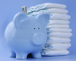 Baby blue piggy bank with diapers on blue