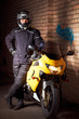 Photo: Biker in a black coats and helmet and his motorcycle Biker in a black coats and helmet and his motorcycle