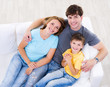Laughing family with son on the sofa