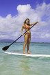 teenage girl in bikini on a paddle board in hawaii teenage girl in bikini on a paddle board in hawaii