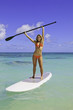 teenage girl in bikini on a paddle board in hawaii teenage girl in bikini on a paddle board in hawaii