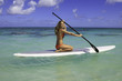 teenage girl in bikini on a paddle board in hawaii teenage girl in bikini on a paddle board in hawaii