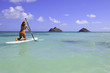 teenage girl in bikini on a paddle board in hawaii teenage girl in bikini on a paddle board in hawaii
