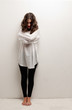 Young insane woman with straitjacket standing looking at camera