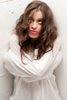 Young insane woman with straitjacket looking up camera close-up