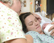Photo: Mother and grandmother with newborn baby right after delivery Mother and grandmother with newborn baby right after delivery
