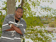 Young African American man with his arms crossed.