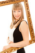 Beautiful woman standing with frame and smiling Beautiful woman standing with frame and smiling