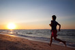 Teen boy runs at the beach on beautiful summer sunset Teen boy runs at the beach on beautiful summer sunset