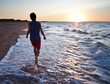 Teen boy runs at the beach on beautiful summer sunset Teen boy runs at the beach on beautiful summer sunset