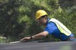 Photo: Maintenance worker measures solar array on rooftop, Los Angeles, California Maintenance worker measures solar array on rooftop, Los Angeles, California