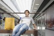 Young man sits in new shopping centre, Voronezh