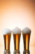 Beer glasses against the colorful gradient background