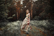Photo: Portrait of romantic woman in fairy forest Portrait of romantic woman in fairy forest