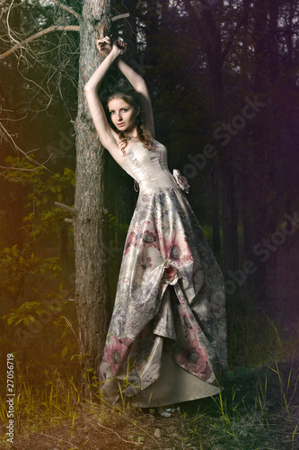 Photo: Portrait of romantic woman in fairy forest Portrait of romantic woman in fairy forest