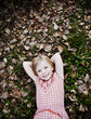 Photo: Cute Girl Laying in Fallen Leaves. Cute Girl Laying in Fallen Leaves.