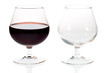 An empty and a full glass of red wine