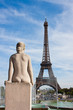 Statue of naked woman looks at Eiffel Tower