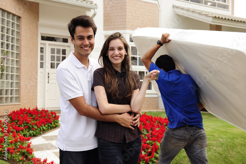 Photo: Moving home: Couple infront of new house Moving home: Couple infront of new house