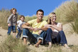 Family Sitting on Beach Having Fun Family Sitting on Beach Having Fun