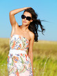 beautiful woman on nature in black sunglasses