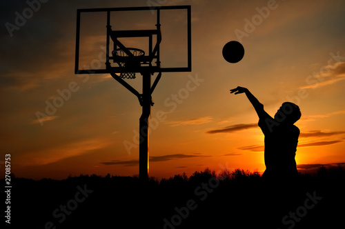 Photo: Silhouette of Teen Boy shooting a Basketball Silhouette of Teen Boy shooting a Basketball