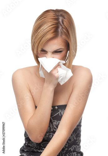 Foto: young woman blowing her nose young woman blowing her nose