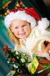 Photo: little girl with gift and Christmas tree little girl with gift and Christmas tree