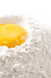 bake it! egg yolk on flour, white backdrop bake it! egg yolk on flour, white backdrop