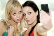 Teenage Girlfriends Taking Photographs. Model Released