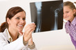 Young female doctor show x-ray to child Young female doctor show x-ray to child