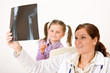 Young female doctor show x-ray to child Young female doctor show x-ray to child