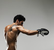 Photo: Naked macho man with boxing gloves against grey background Naked macho man with boxing gloves against grey background