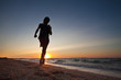 Teen boy runs at the beach on beautiful summer sunset Teen boy runs at the beach on beautiful summer sunset