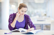 pretty young college student in a library (shallow DOF; color to