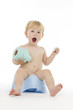 Infant on chamber pot.